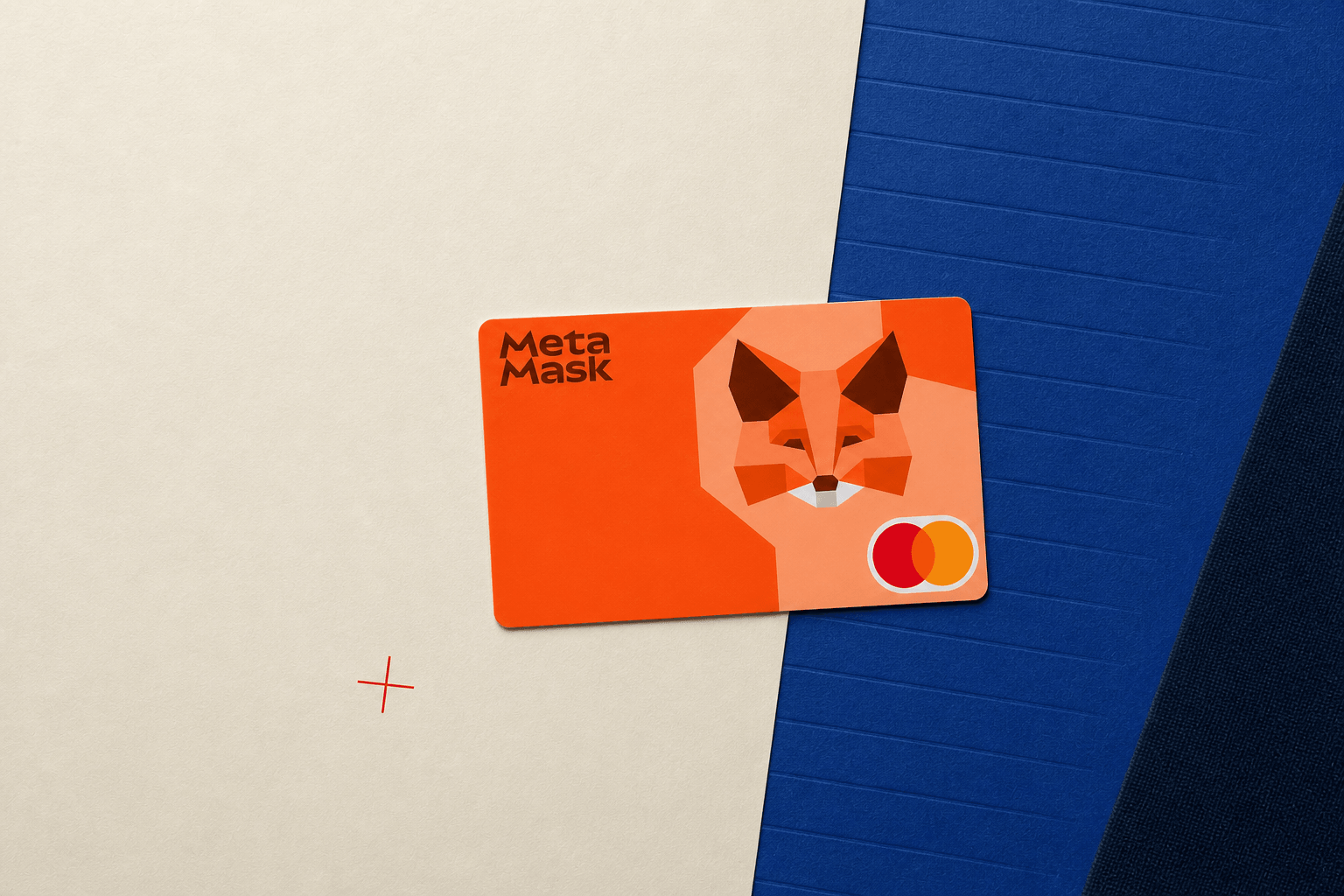 MetaMask Card resting in perspective on an ivory and cobalt editorial ledger surface
