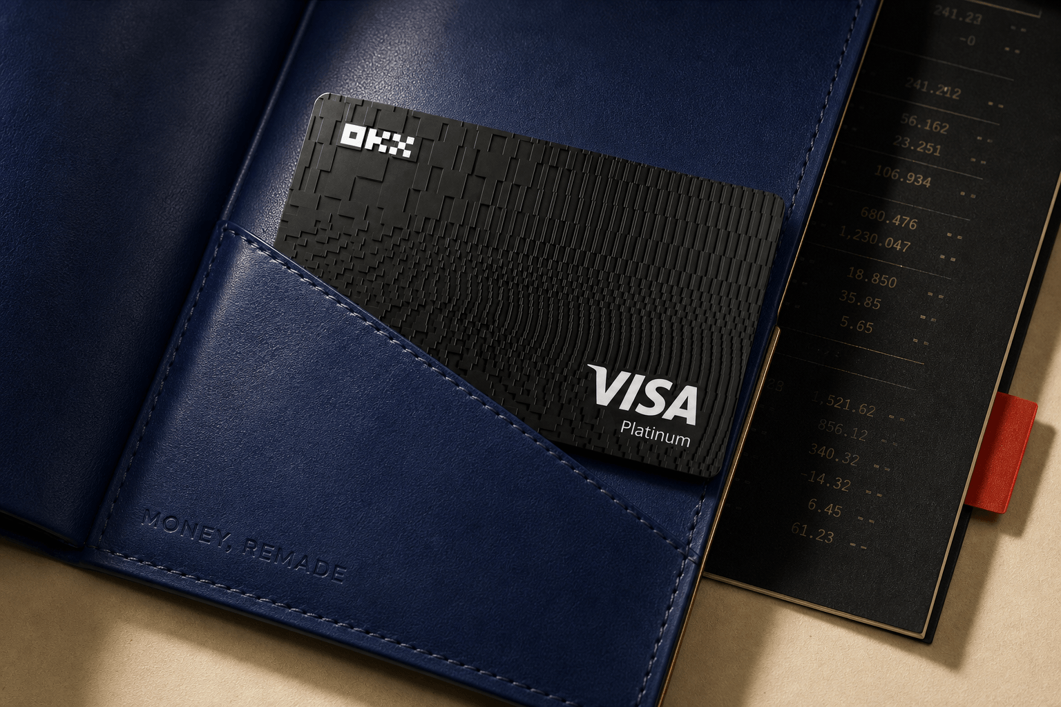 Black OKX Global Visa Platinum card partly drawn from a cobalt Money, Remade folio