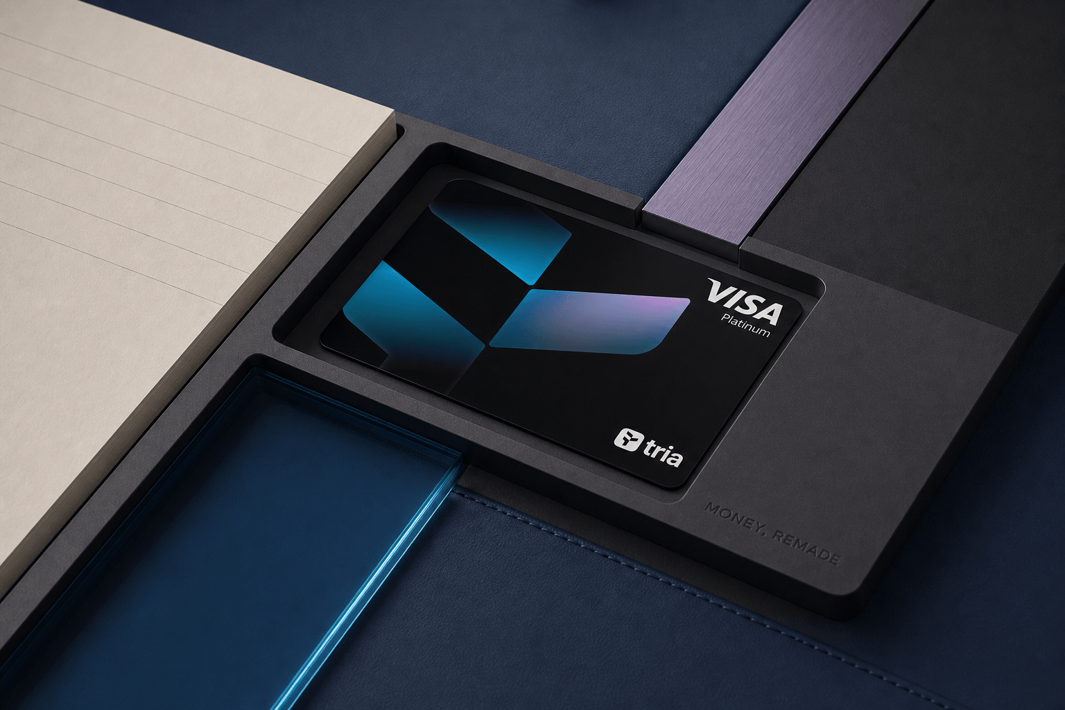 Tria Visa Platinum card resting in a recessed balance tray across cobalt, ink and ivory editorial surfaces